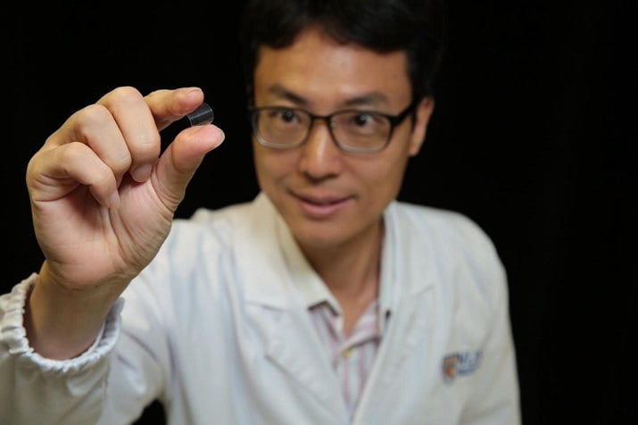 Associate Professor Yang Hyunsoo from the National University of Singapore demonstrates the flexibility of the memory chip. (Image Credit: National University of Singapore) 