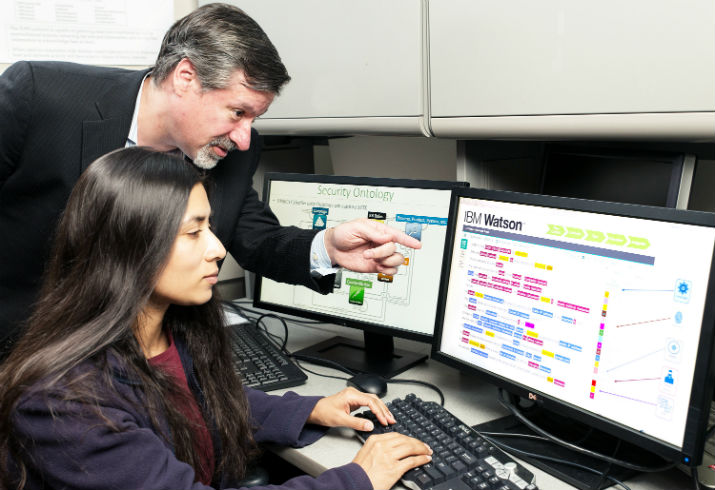 IBM’s Chief Watson Security Architect Jeb Linton demonstrates to student Lisa Mathews how to teach IBM’s Watson the language of security. (Image Credit: Mitro Hood/Feature Photo Service for IBM) 