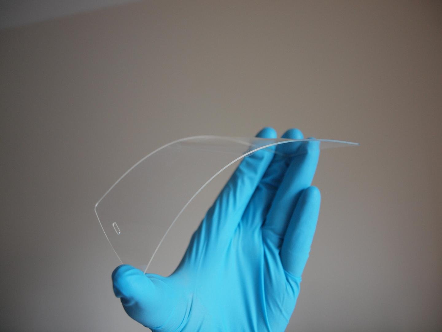 Dr Matthew Large, University of Sussex, flexes a screen made from acrylic plastic coated in silver nanowires and grapheme to illustrate the kind of touch screens that can potentially be produced using the new approach. Source: Dr. Matthew Large