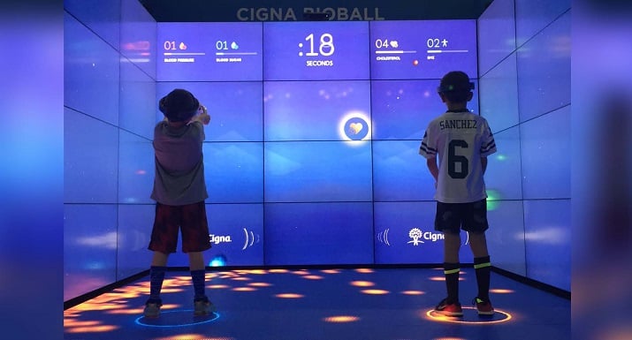 An interactive game allows players to learn their blood pressure and body mass index and receive the results privately through their headsets. Source: Cigna  