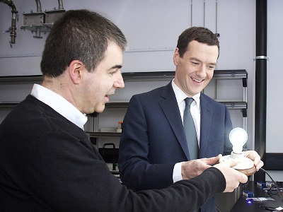 Sir Konstantin Novoselov (left) shows George Osborne, the UK's chancellor of the Exchequer, a prototype of Graphene Lighting's LED lightbulb.