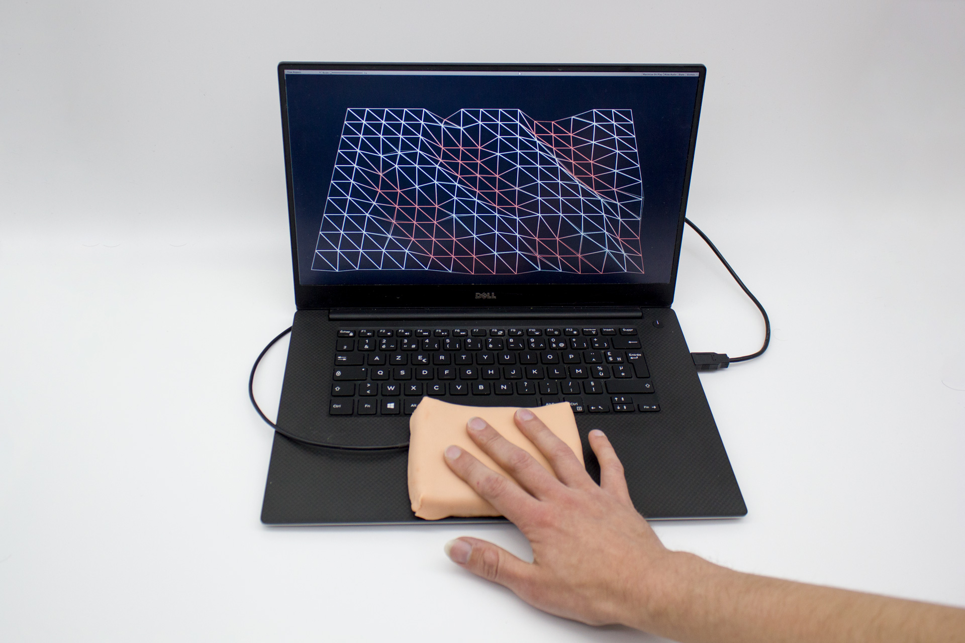 A new interface developed by researchers in Bristol and Paris takes touch technology to the next level by providing an artificial skin-like membrane for augmenting interactive devices such as phones, wearables or computers Source: Marc Teyssier
