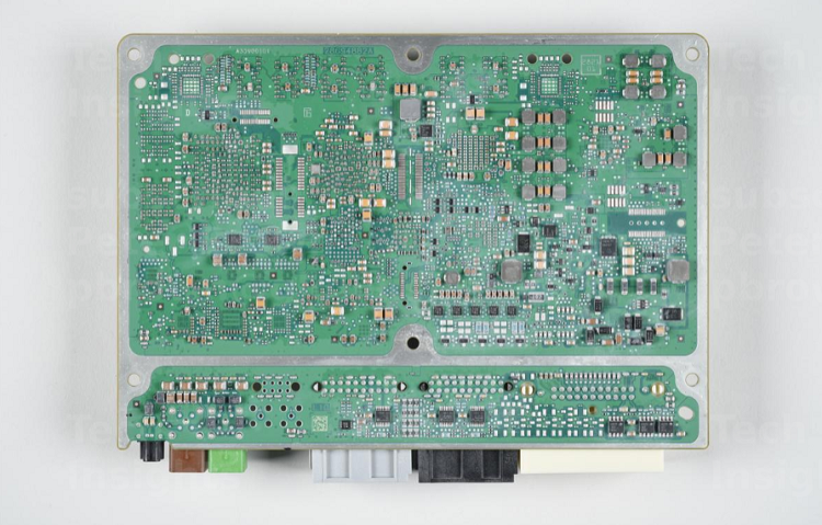The bottom side of the main board of the F-150 Lightning ECU has more of the discrete components and power management ICs. Source: TechInsights 