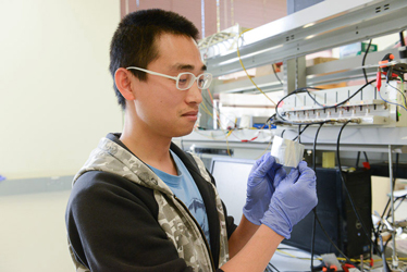 One of Professor Hongjie Dai's colleagues demonstrating the aluminum-ion battery. Source: Stanford