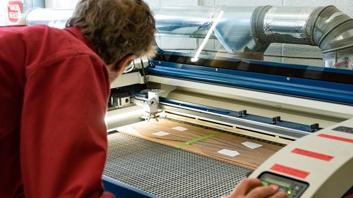 Figure 2: Preparing to cut/engrave wood on a Fusion M2 at BLDG 61: Boulder Library Makerspace, in Boulder, Colorado. Source: Epilog Laser