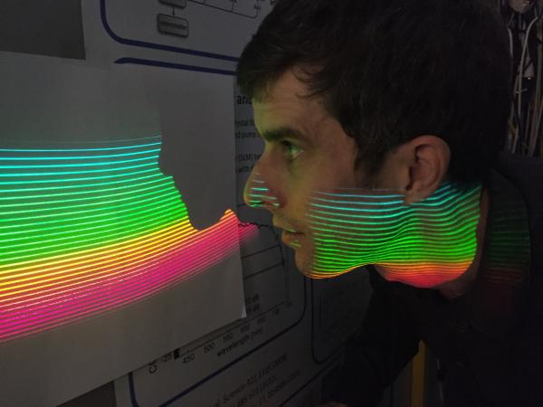 Comb modes of the ESPRESSO-AstroComb are projected onto a screen by means of an echelle spectrograph. Source: Menlo Systems