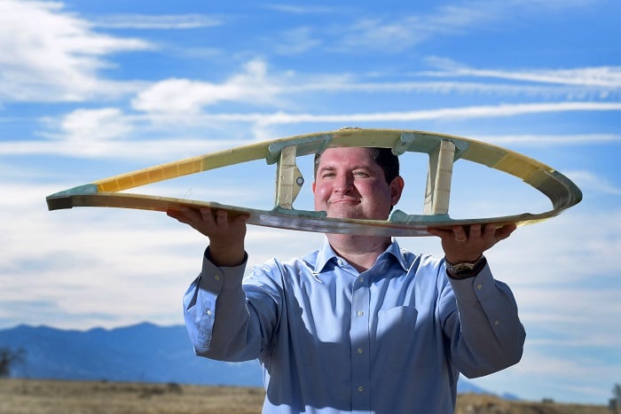 Todd Griffith with a cross-section of a 50-meter blade, part of the pathway to the 200-meter exascale turbines planned under the DOE. (Source: Randy Montoya)