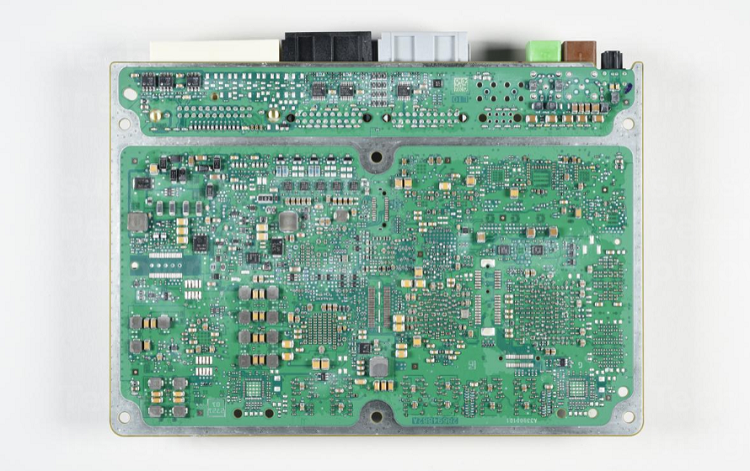 The back side of the main board on the ADAS controller features discrete and electronic components needed to operate the safety systems. Source: TechInsights