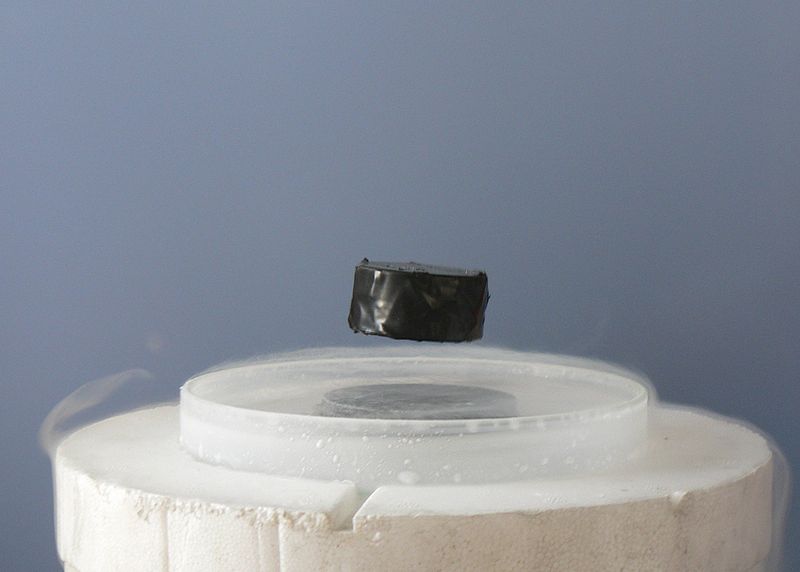 Photo of a magnet levitating above a superconductor. (Image Credit: Mai-Linh Doan)