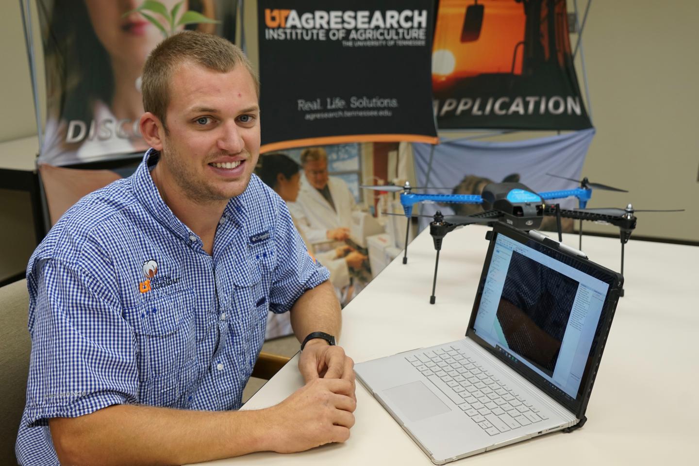Shawn Butler, a graduate student at the University of Tennessee College of Agricultural Sciences and Natural Resources, analyzes cotton research plots from his laptop thanks to images obtained with an unmanned areial system (UAS), also called a drone. This research could help farmers improve crop monitoring. (Ginger Rowsey)
