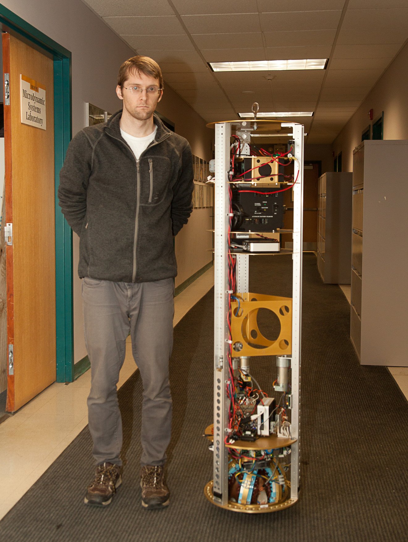 Carnegie Mellon University graduate Greg Seyfarth poses with SIMbot.   