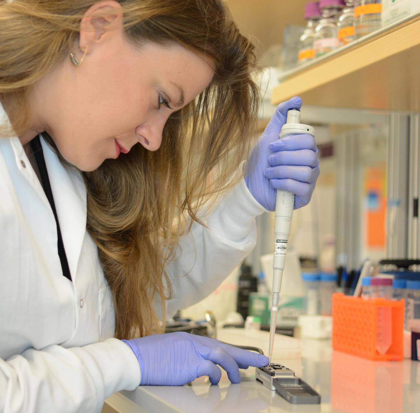 Researcher Sophie Zaaijer uses the MinION, a portable DNA sequencer, to get a quick genetic readout of a sample of cells.Source: New York Genome Center