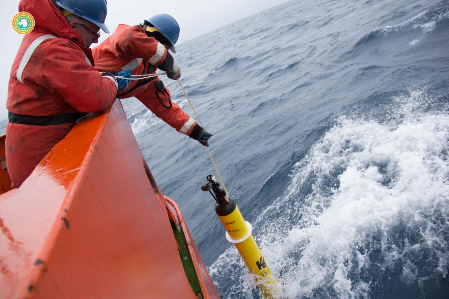 Stephen Riser (left) drops a float into the Southern Ocean during a 2016/17 cruise. (Source: Greta Shum/ClimateCentral)
