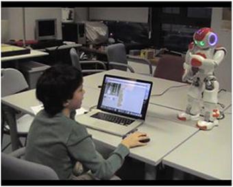 A student completing tasks on a computer receives feedback from a robotic tutor.  Image Credit: Luis-Eduardo Imbernòn Cuadrado, SOPRA Steria, Madrid, Spain