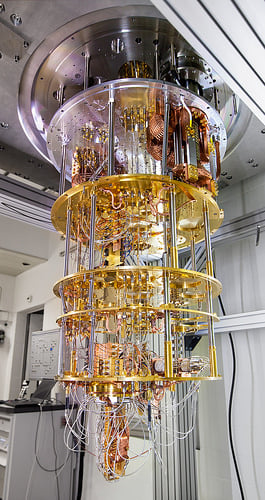 Each descending level of a dilution refrigerator is cooled to a lower temperature. The quantum chip rests at the bottom at a frigid 15 mK above absolute zero. Source: IBM