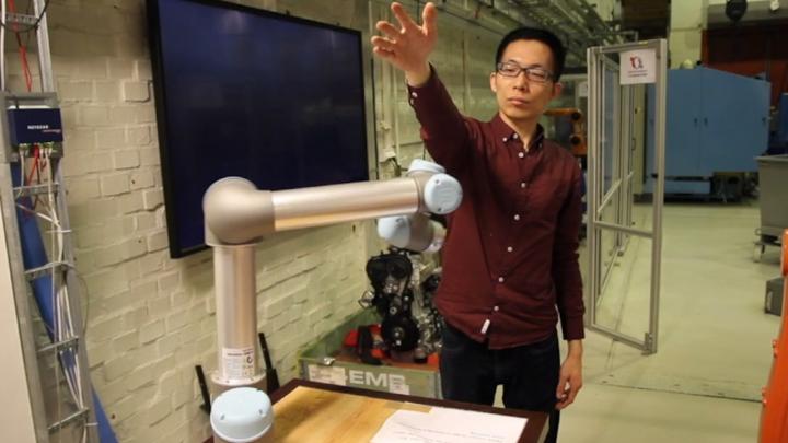 KTH researcher Hongyi Liu tests a robot arm by placing his hand in its path. Source: Hongyi Liu