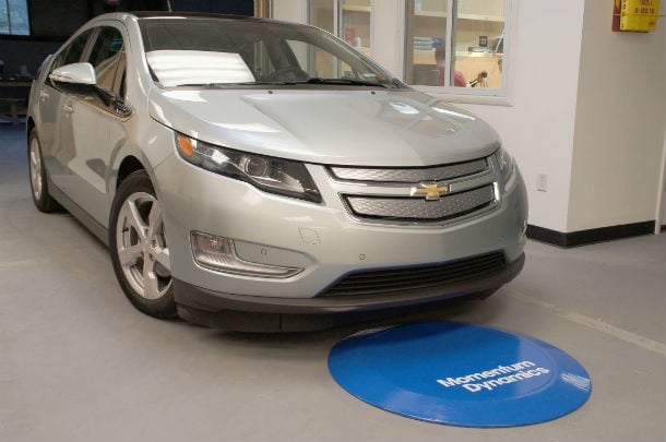Momentum uses a transmitter on the ground and a power receiver mounted to the underbelly of an electric vehicle to enable wireless charging. Source: Momentum Dynamics 