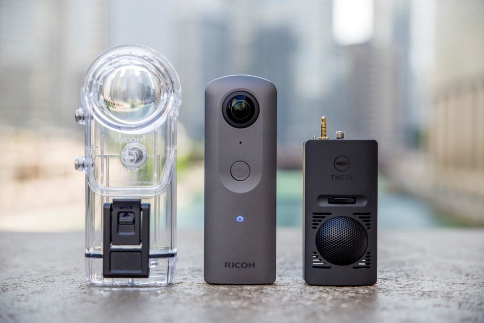 Ricoh Theta V 360-degree camera with 4K video and spatial audio (center) was announced today, along with accessory Underwater Case TW-1 (left) and 3D Microphone TA-1 (right). Source: Ricoh