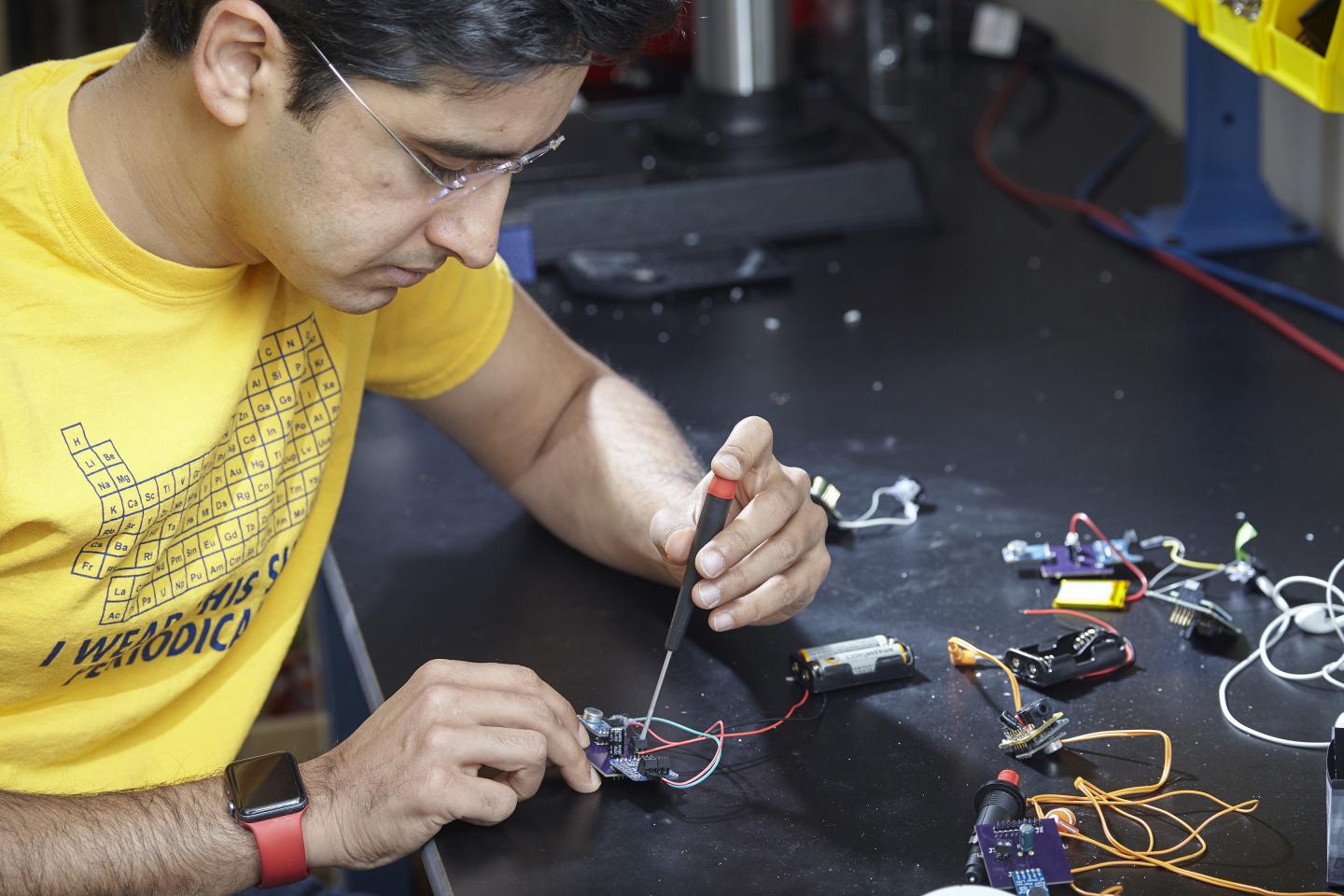 Georgia Tech assistant professor M. Saad Bhamla assembles a prototype LoCHAid, an ultra-low-cost hearing aid built with a 3D-printed case and components that cost less than a dollar. Source: Craig Bromley