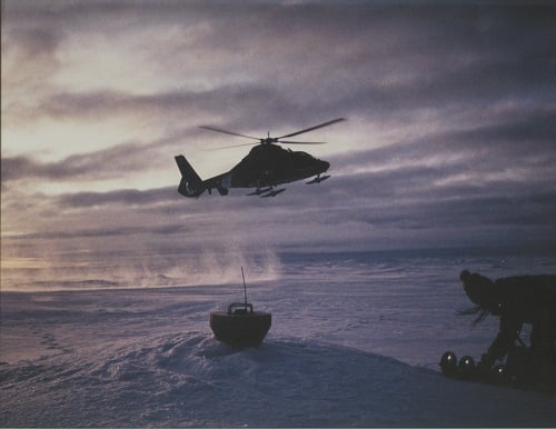 Figure 1a: Oceantronic's GPS/ice buoy being retrieved by helicopter to the Arctic for use in experiments measuring wind, temperature sunlight and ice thickness near the North Pole. Oceantronics’ hybrid lithium pack provides the same operating life with smaller size for use in GPS/ice buoys. (Image credit: Sigrid Salo NOAA/PMEL)