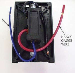 This is the back of the line voltage thermostat shown in Figure 7. The factory wiring is a heavy-gauge wire that can handle higher amperage conditions than a low-voltage thermostat. Source: Ahmed Faizan Ahmed