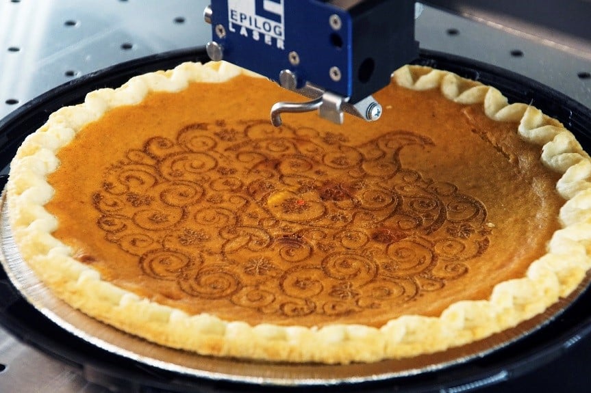 Laser engraving isn’t just for materials such as metal and wood. Here, an Epilog Laser system creates a custom Thanksgiving pie. Source: Epilog Laser